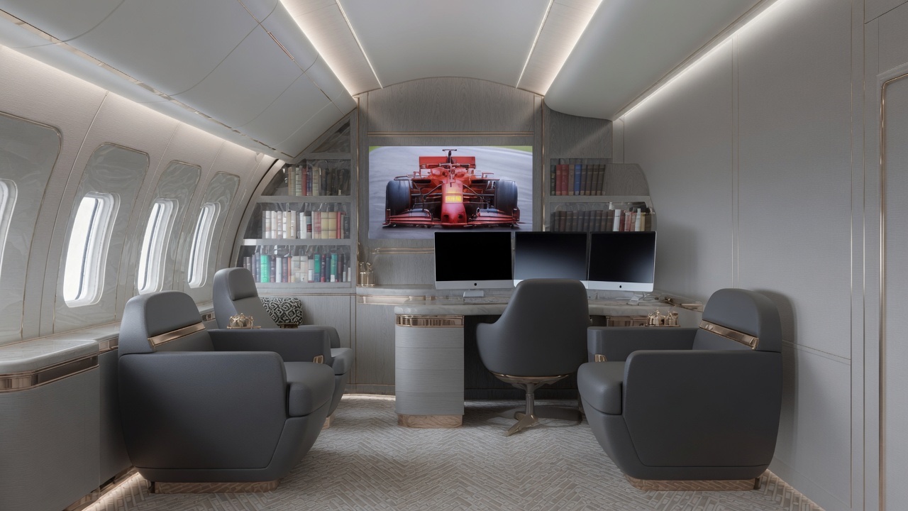 Boeing 777 VIP cabin with private office desk, lounge seating and media wall
