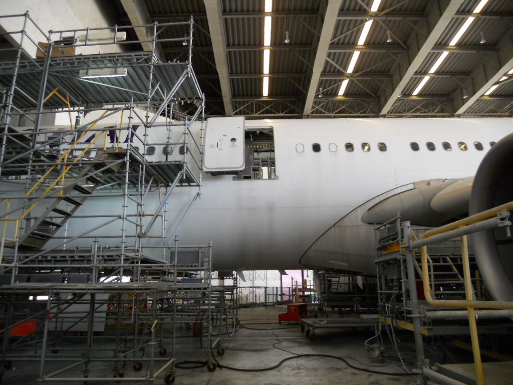 Wide-body aircraft in maintenance hangar — IAS aircraft lease management and redelivery inspection services